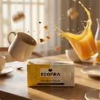 Box of Ecofira bamboo tissues on a table with a glass of orange juice and a mug.