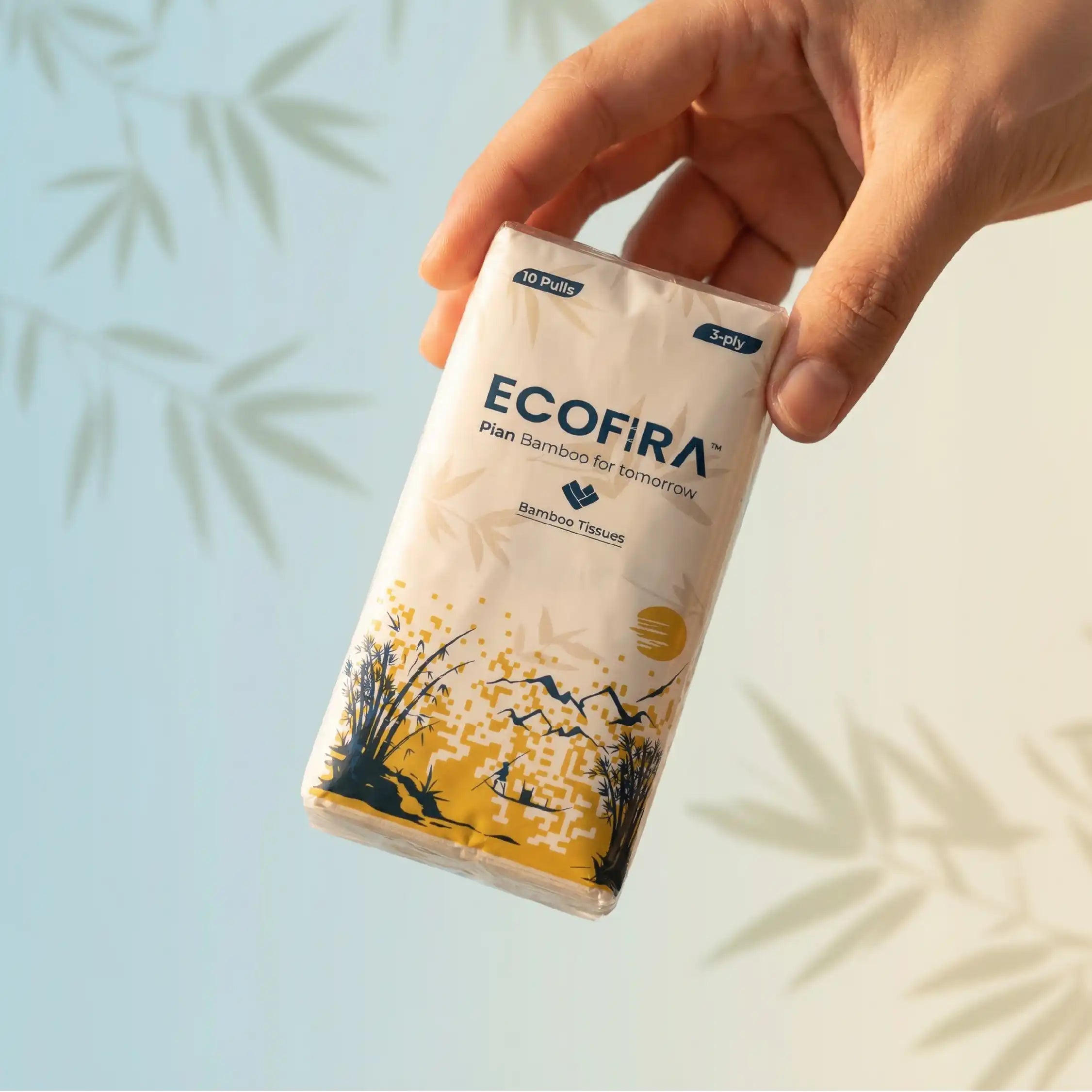 Hand holding a pack of Ecofira bamboo tissue paper with a light blue and white background.
