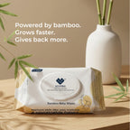EcoFira bamboo baby wipes packaging on a wooden surface with a vase and plant in the background.