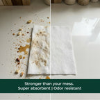 Comparison of a stained paper towel with a clean one, highlighting absorbent properties.