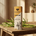 Box of Ecofira reusable bamboo kitchen towels on a wooden table with bamboo leaves.