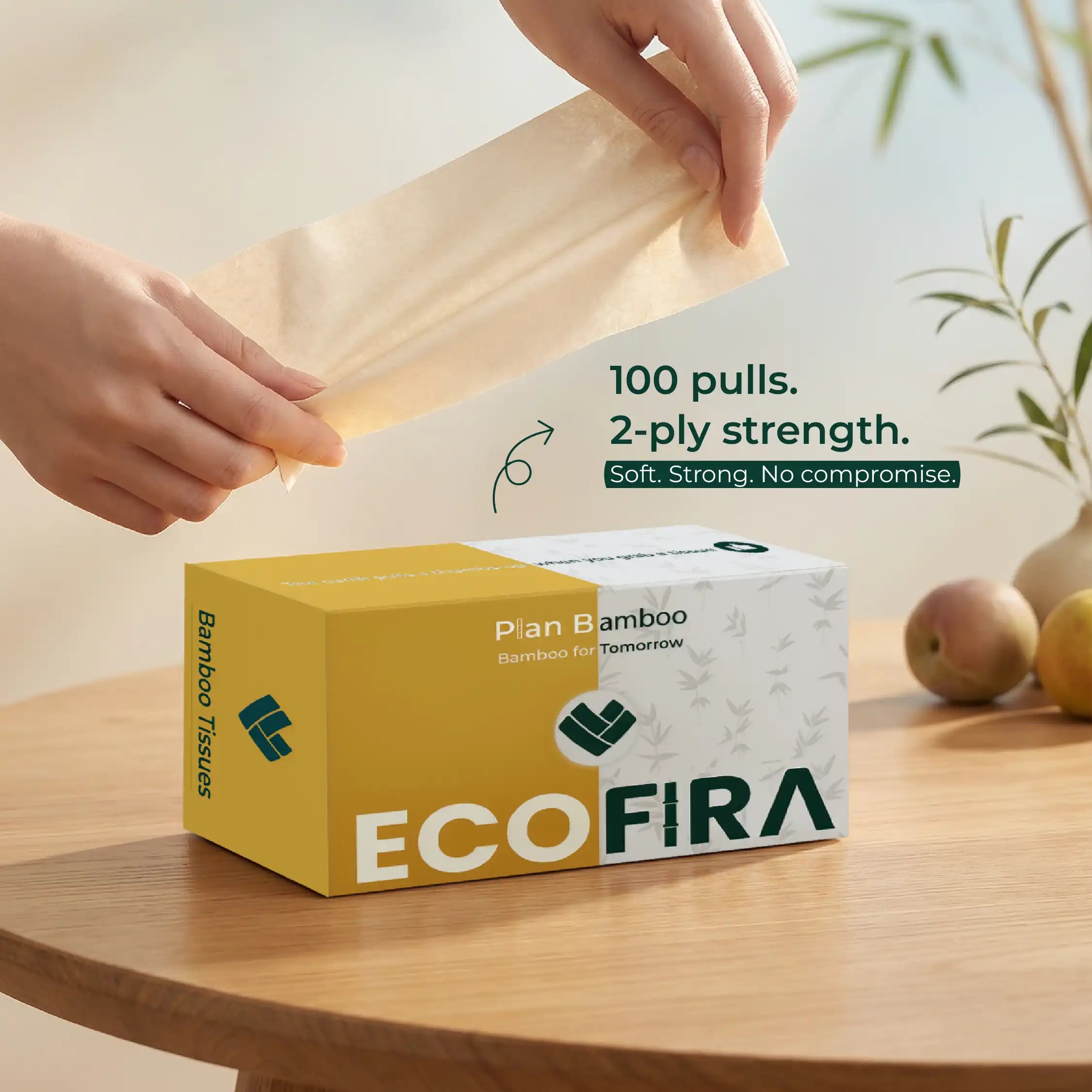 EcoFira bamboo tissues box with a hand pulling a tissue, set on a wooden surface.